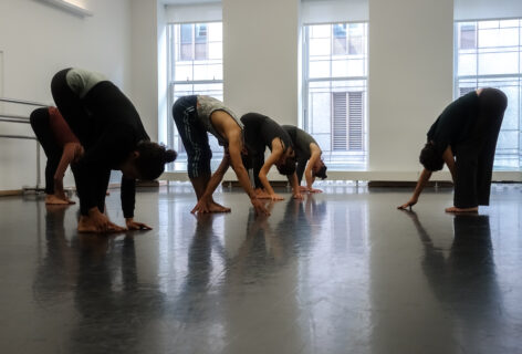Students with torsos bent at the waist during class. Heads are hanging. Photo by Harry Shunyao Zhang.