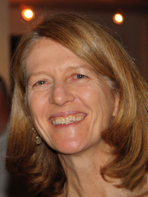 Photo of Martha Eddy smiling into the camera. She has honey blonde hair styled in a mid length bob. Photo courtesy of the artist.