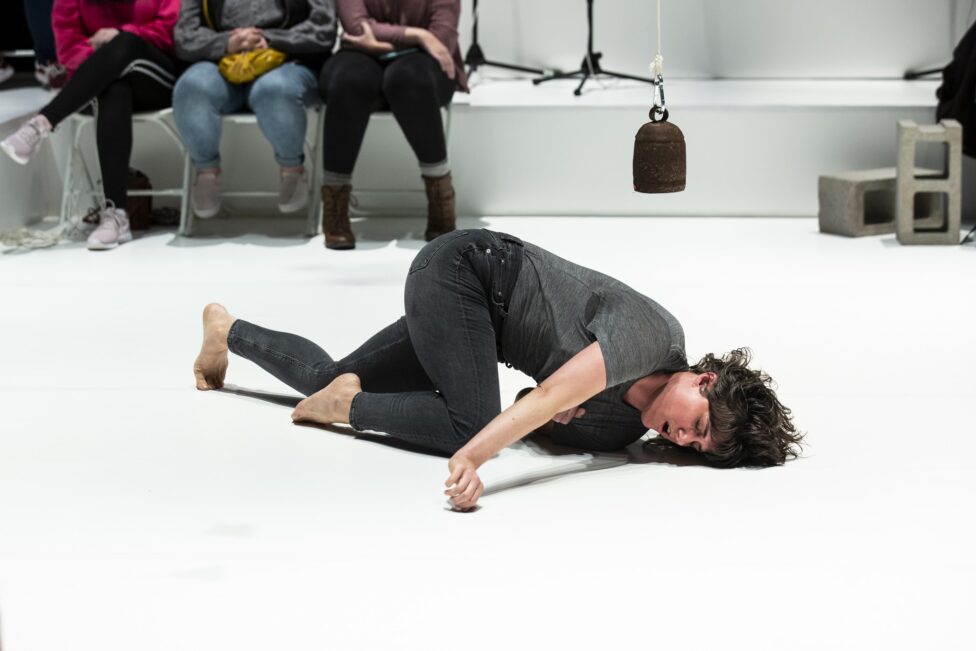 Faye Driscoll performing, crawling on the ground.