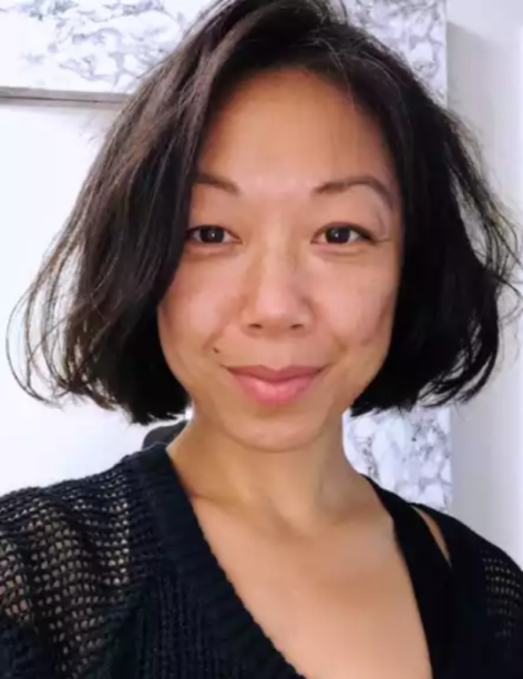Portrait of Kayva Yang looking int the camera. She has dark hair in a bob haircut and wears a dark colored top. She looks into the camera with a smile. Photo courtesy of the artist.