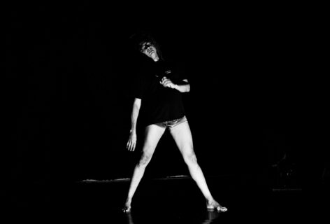 Person in shadow almost imperceptible, with legs spread wide standing and leaning. Photo courtesy of the artist.