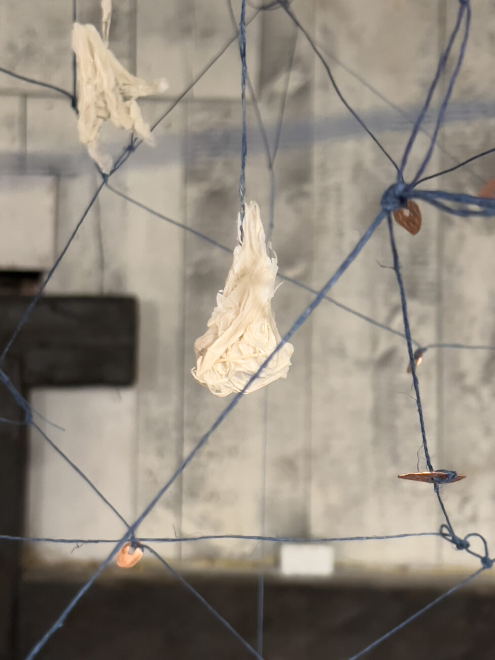 Close up of a detail from installation, Walking at Night, 2023. Life Cycle of the tree through the hands of humans. Medallions.