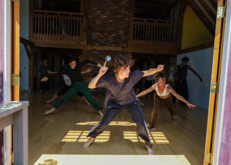 Several dancers falling to the side in a weight shifting exercise. Image captured at The Field Center in Summer 2024. The studio is warmly lit by the sun streaming through the windows. Photo by Rosa Wolff at The Field Center.