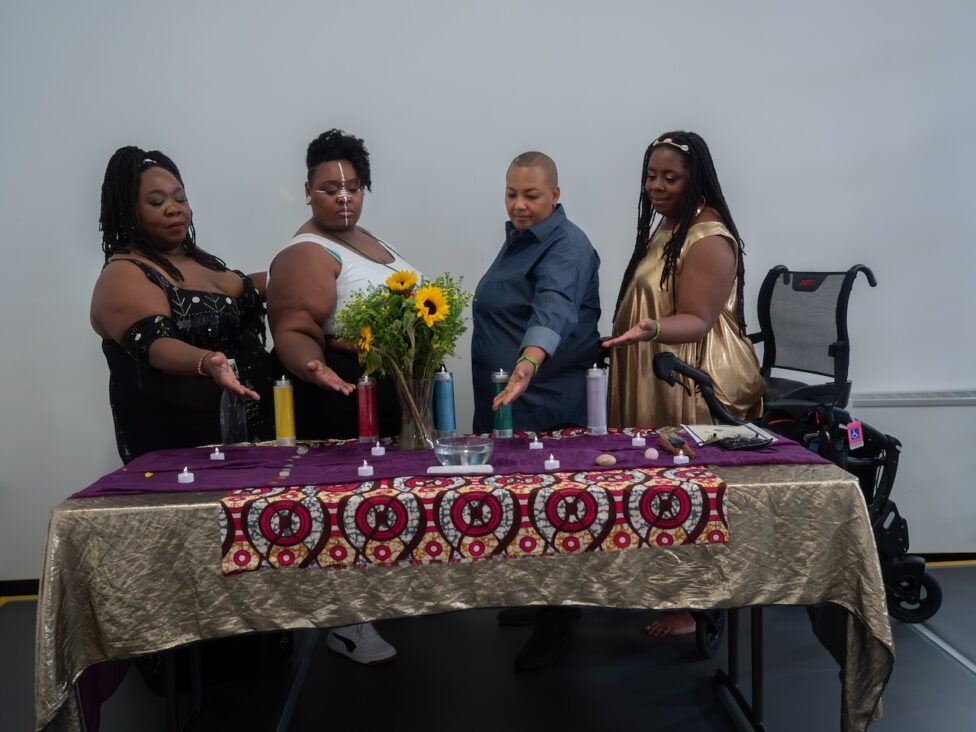 AMP Residency photo: India Harville and artists stand behind a table prepared as an altar.