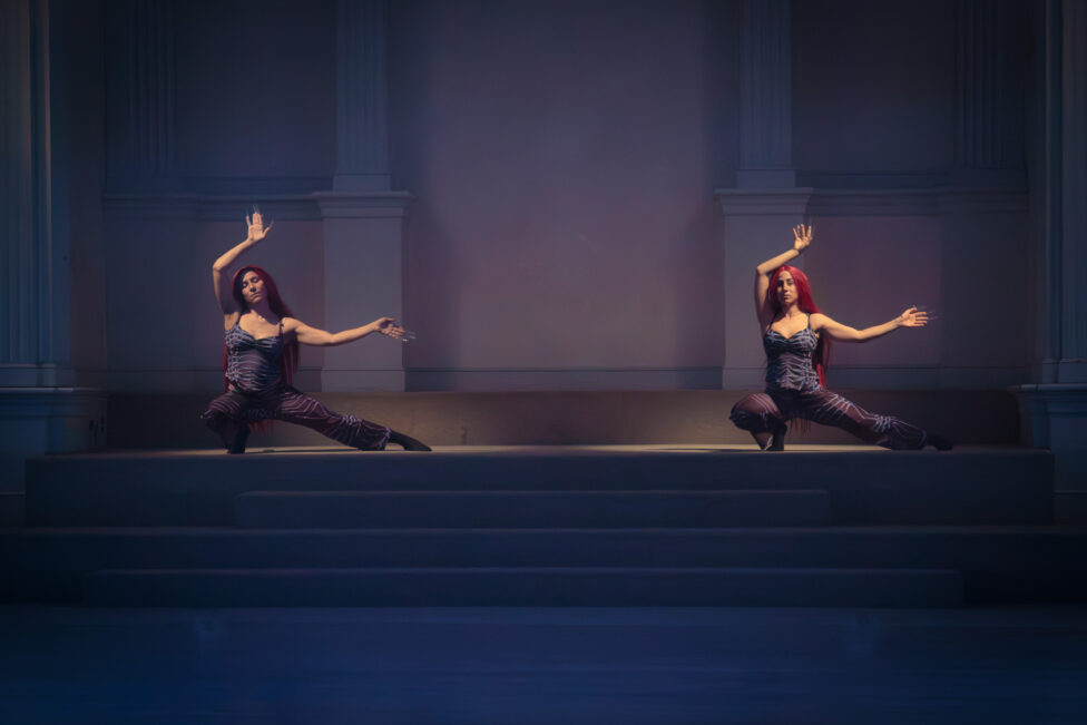 Photo from the MR Festival in 2024; Nasa4Nasa performance at Dancespace Project; they lunge on their right leg and stretch their left leg out to the side. They gesture their arms above their head and to the side. Photo by T Turner.