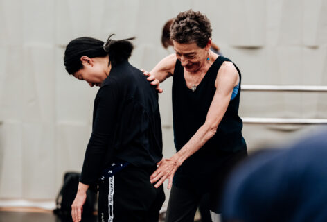 Barbara Mahler assists a student during a class. Barbara touches the student's back. Photo courtesy of the National Performing Arts Center - National Kaohsiung Center for the Arts.