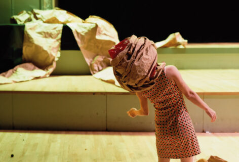 Nami with fabric wrapped around her head, leaning towards her right. Photo by Ryutaro Mishima (Headless Wolf)—Nami Yamamoto in Headless Wolf