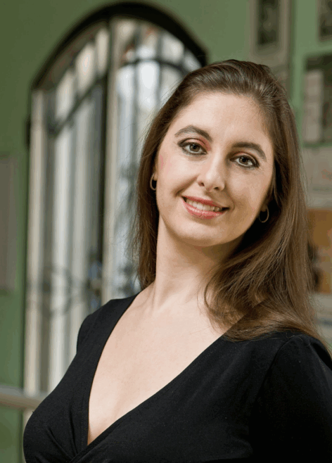 Anabella wears a black top and smiles. Photo credit to Todd Carroll.