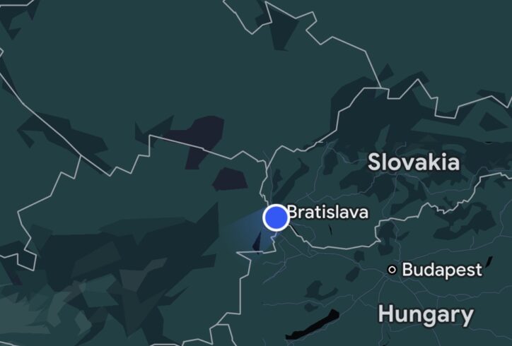 The image is a map that shows surrounding countries with bold border outlines, including Austria to the west and the Czech Republic to the north. The background is dark with varying shades of green and blue to indicate terrain or regions, and there's a compass/navigation icon in the bottom-right corner. The map suggests the user is near the border region between Slovakia and Austria.