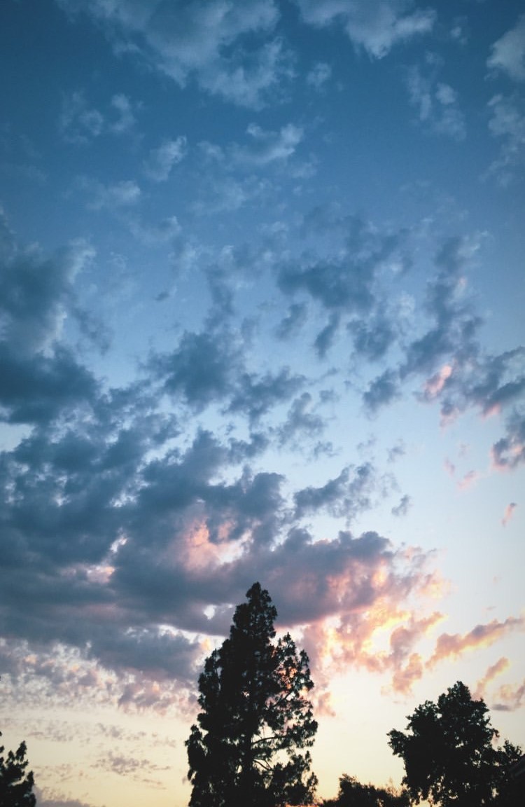 An image of a sunset, the sky is blue, purple, pink, and yellow. 