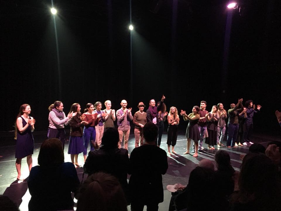 An image of a line of dancers all applauding on a stage. The Box, Riverside 