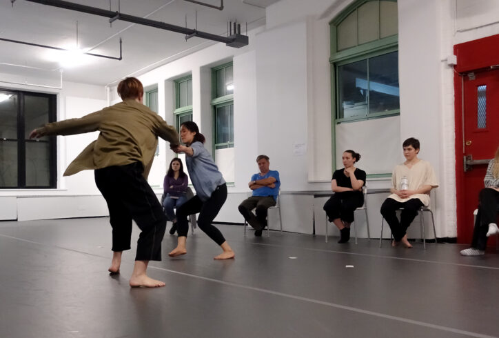 Two dancers presenting for Open Performance they move in the space with a bend in their knees. Photo by Harry Shuanyao Zhang.